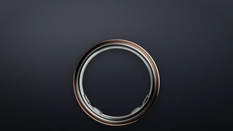 Oura Ring 5 in the Deep Rose finish seen from the side against a dark background