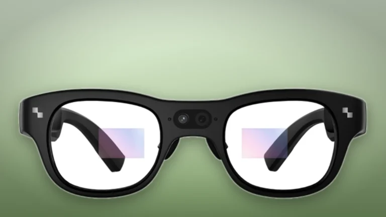 Front view of the black RayNeo X3 Pro frame with its two bridge cameras and faint display areas in both lenses, on a soft green background