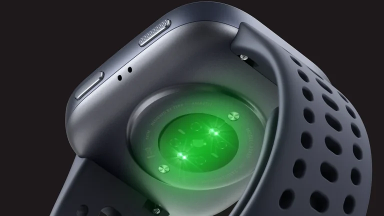 Underside of the Black Amazfit Bip 6 with the BioTracker optical sensor glowing green, and the perforated strap curving around it