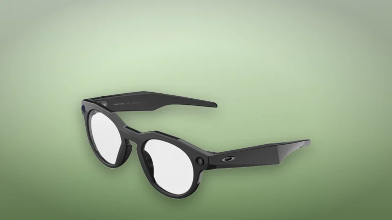 Black Oakley Meta HSTN glasses with clear lenses at an angle on a soft green outdoor backdrop
