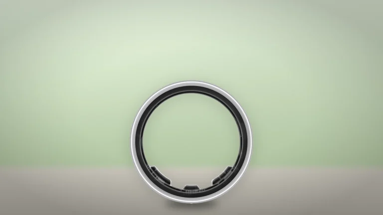 Galaxy Ring in Titanium Silver seen face-on as a circle against a pale green backdrop